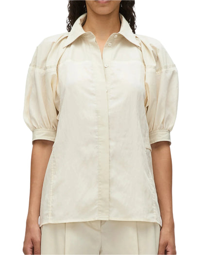 Wearing the 3.1 Phillip Lim Lantern Sleeve Combo Shirt exudes feminine elegance with its subtle yet structured silhouette, featuring light beige fabric and puffed short sleeves.