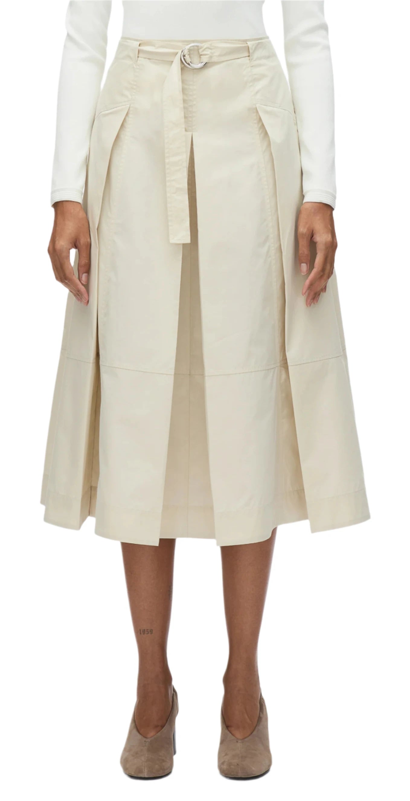 A person wearing a white long-sleeve top and the 3.1 Phillip Lim Utility Pleated Skirt with Belt, paired with beige shoes, stands against a plain background. This versatile piece from 3.1 Phillip Lim is perfect for any occasion.