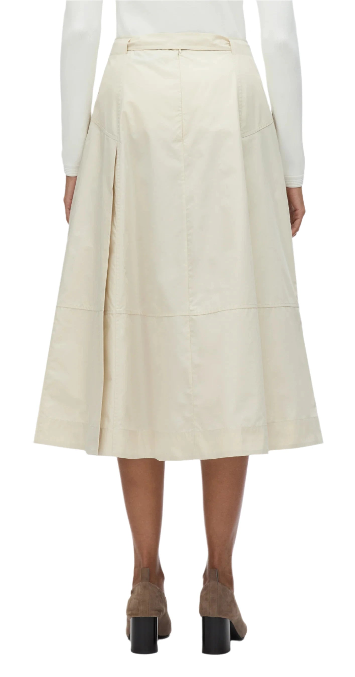 A model displays a white long-sleeve top combined with the 3.1 Phillip Lim Utility Pleated Skirt with Belt, featuring constructed pleats in a beige A-line design, elegantly finished with brown high-heeled shoes. This versatile piece is shown from the back, emphasizing its timeless charm.