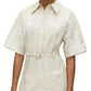 Someone dressed in the 3.1 Phillip Lim Cascade Belted Combo Lace Shirt Dress showcases a blend of casual elegance with its lace panels on the shoulders and a waist-cinching belt.