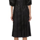 A woman in a black 3.1 Phillip Lim Lantern Sleeve Sweatshirt Dress, adorned with elegant lantern sleeves, viewed from the back.