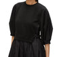 A person wearing the 3.1 Phillip Lim Lantern Sleeve Sweatshirt Dress in black.