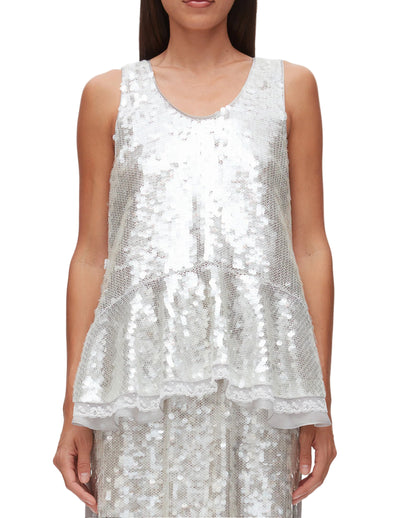 A woman wears the 3.1 Phillip Lim Sequin Flounce Tank with Bows, featuring sparkling sequins and a flounced hem, against a plain background.
