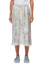 A person styles the 3.1 Phillip Lim Sequin Pull On Skirt with a white top and light blue sneakers, featuring a white elastic drawstring waistband.