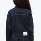 A person with long curly hair wears the 3.1 Phillip Lim Denim Boxy Jacket, photographed from the back against a plain background.