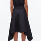 A person faces away in a sleeveless black Ruched Handkerchief Dress by 3.1 Phillip Lim, crafted from technical poplin with a handkerchief hemline, paired with black shoes against a plain white background.