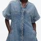 A model wears the 3.1 Phillip Lim Trapeze Light Denim Dress, a short-sleeve style with front seams, side pockets, and a trapeze silhouette, shown from shoulders to above the knees.