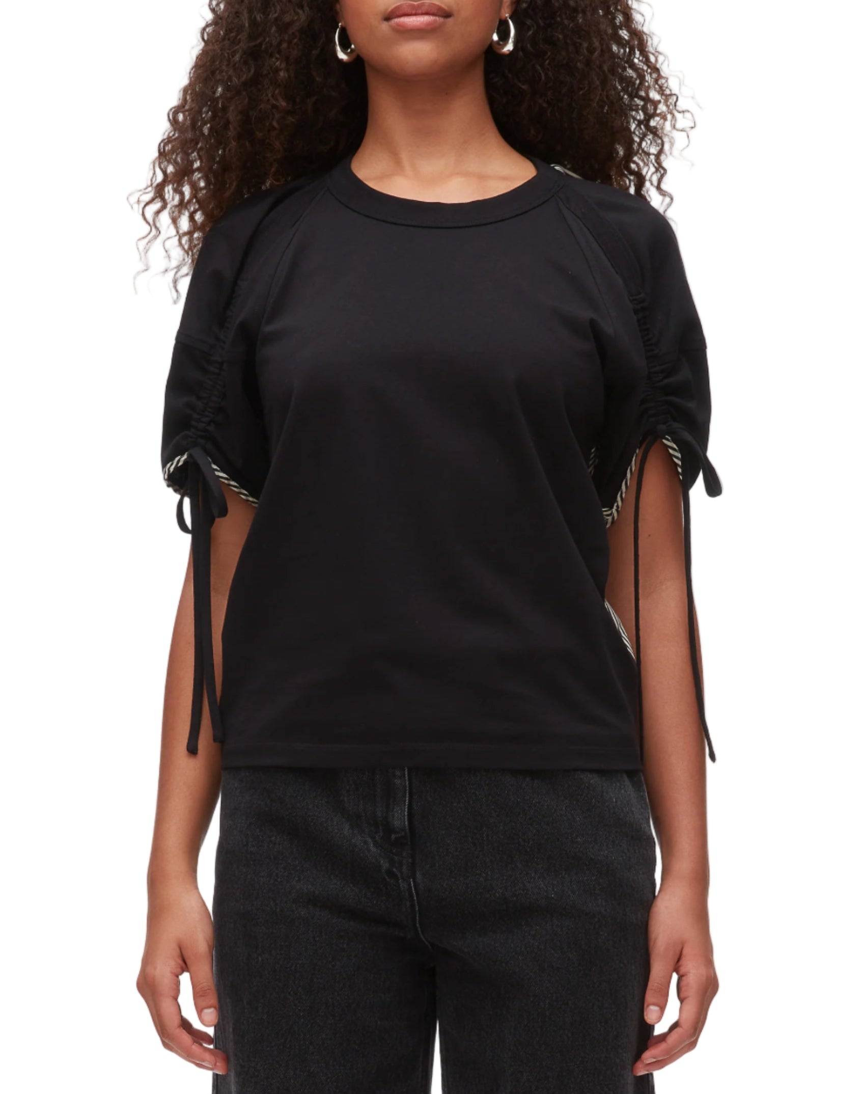 A person wearing the 3.1 Phillip Lim Ruched T-Shirt with Combo Panel Back and black jeans stands against a white background.