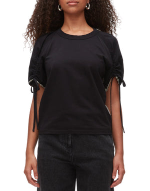 A person wearing the 3.1 Phillip Lim Ruched T-Shirt with Combo Panel Back and black jeans stands against a white background.