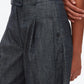 A person wearing 3.1 Phillip Lim's Denim Double Pleat Wide Leg Pant in dark denim, paired with a white ribbed top, shown from waist to mid-thigh.