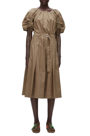A person wearing the 3.1 Phillip Lim Ruched Sleeve Midi Dress in tan cotton poplin with a D-ring belt and brown loafers stands facing forward against a white background.