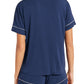 Person wearing the Eberjey Gisele Relaxed Short PJ Set in navy blue with white piping, crafted from luxurious knit fabric, viewed from the back.