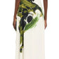 Rear view of a person in a Jason Wu Collection Boatneck Fit and Flare Crepe Dress, showcasing an abstract green and black brushstroke print, elegantly paired with black heels.