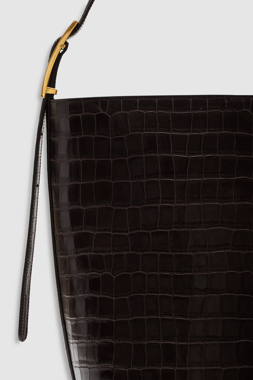 Anine Bing Elly Bucket Embossed Bag in black crocodile-embossed leather with gold-tone hardware and a metal strap attachment.