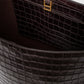 Interior view of an Anine Bing Elly Bucket Embossed Bag in dark brown crocodile-embossed leather with gold-tone hardware at the closure.