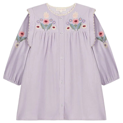 The Louise Misha Baby Girls’ and Girls’ Anette Dress is a light purple long-sleeve corduroy dress with front buttons, colorful floral embroidery on the chest and sleeves, and a charming embroidered yoke, displayed against a white background.