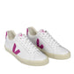 The VEJA Esplar Leather Women's Sneakers by Veja are a stylish pair of white leather shoes featuring purple "V" logos on the sides, white laces, beige soles, and purple accents on the tongues and heels. Stitched detailing adds a touch of craftsmanship to this elegant footwear.