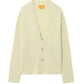 Guest in Residence Everywear Cardigan in light green, featuring a classic V-neckline and three brown front buttons, displayed flat on a white background.