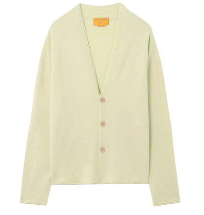 Guest in Residence Everywear Cardigan in light green, featuring a classic V-neckline and three brown front buttons, displayed flat on a white background.