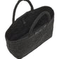The East West Raffia Chelsea Tote by Proenza Schouler is shown empty in black, featuring two handles and photographed from an angled, overhead perspective—this sophisticated piece channels the refined silhouette of a structured handbag, seamlessly uniting practical design with contemporary style.