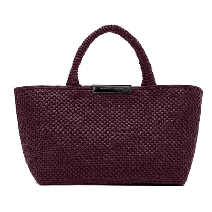 The Proenza Schouler East West Raffia Chelsea Tote is a structured handbag in dark burgundy with two handles and a black rectangular label on the front, effortlessly combining style and sophistication.