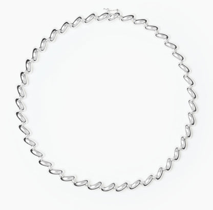 The Edith Necklace by Lie Studio features sterling silver-plated, curve-shaped links in a repeating oval pattern for an elegant, timeless look.