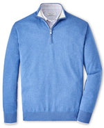 A light blue Peter Millar Whitaker Quarter-Zip Sweater, crafted in a cozy cotton-Tencel blend, featuring a quarter-zip design and a checkered shirt collar visible underneath, perfect for those seeking a Classic Fit.