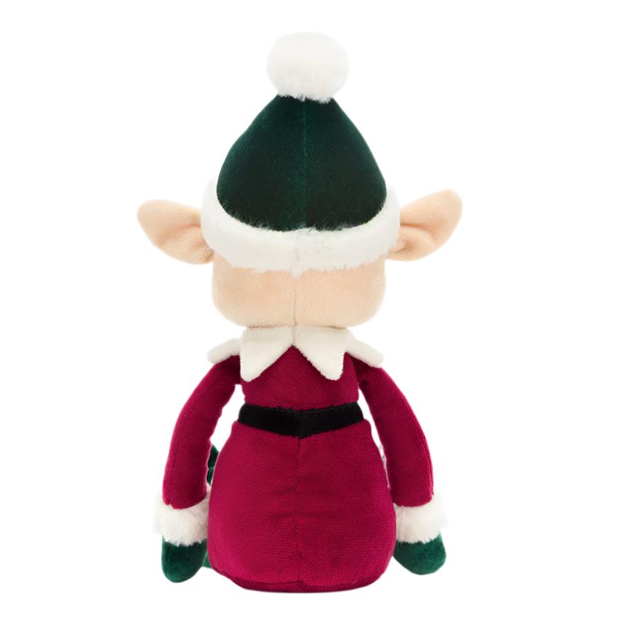 Back view of a plush Jellycat Eldo Elf doll, showcasing a green hat with a white pom-pom and a red outfit with white cuffs, spreading Christmas cheer.