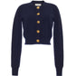 The Cara Cara Ellery Cardigan is a navy blue, crewneck sweater with long sleeves and gold floral buttons down the front, shown on a white background.