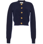 The Cara Cara Ellery Cardigan is a navy blue, crewneck sweater with long sleeves and gold floral buttons down the front, shown on a white background.