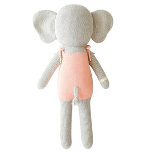 Eloise the Elephant - Little 13" by Cuddle + Kind: a knitted stuffed elephant with large ears, grey body, and pink romper shown from the back—a charming birthday gift that makes lasting memories.