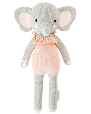 Eloise the Elephant - Little 13" by Cuddle + Kind is a knitted savanna stuffed animal with large ears, a pink ruffled collar, and a light pink body—an adorable birthday gift to cherish.