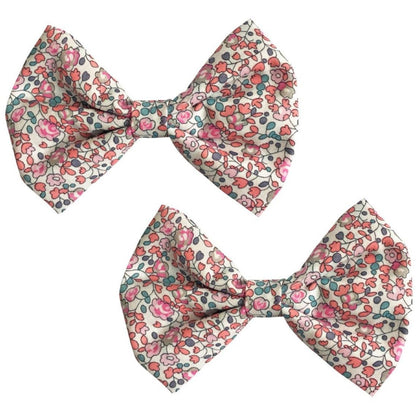 The Milledeux® Large Bowtie Bow Liberty Eloise C set includes two handmade hair clips featuring fabric bows with a pink floral pattern on a white background, crafted by Milledeux.