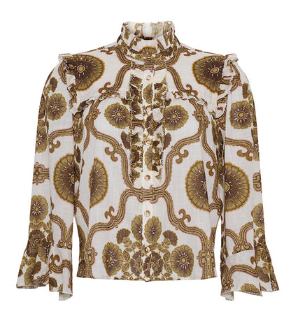 The Elowen Top by Cara Cara is a long-sleeved blouse featuring a ruffle collar, ruffled shoulders, and a brown and gold floral print on white.
