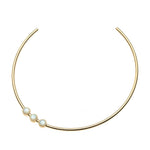 A gold Neck Cuff by Jane Win featuring three evenly spaced white pearls set in gold bezels on one side.