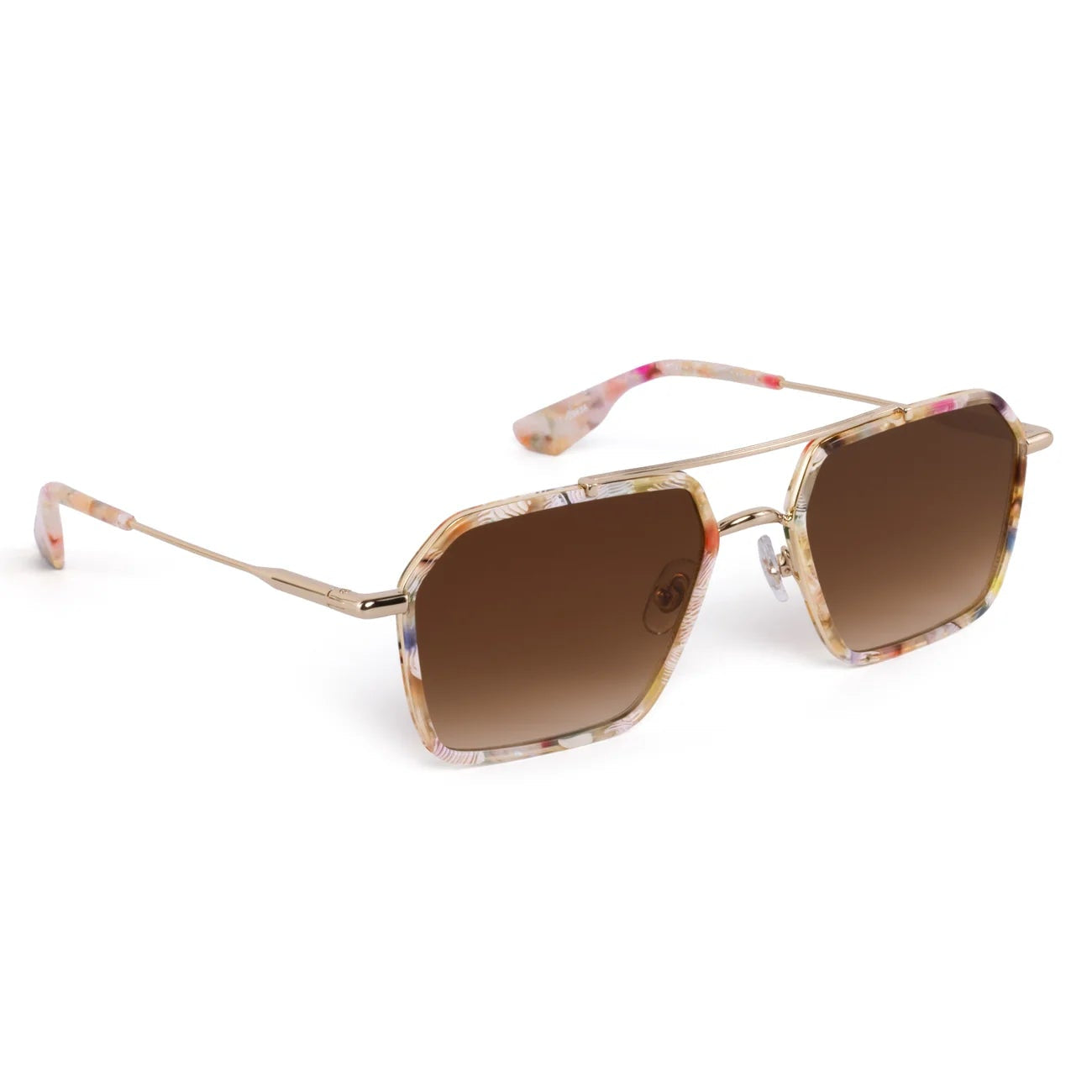 The Krewe Emery Sunglasses feature a unisex frame with gold-tone metal arms, a light pink and beige marbled design, and brown gradient lenses, shown on a white background.