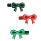 The Meri Meri Enamel Bow Hair Clips by brand Meri Meri, showcasing designs in dark green, red, and light green, are displayed against a white background.