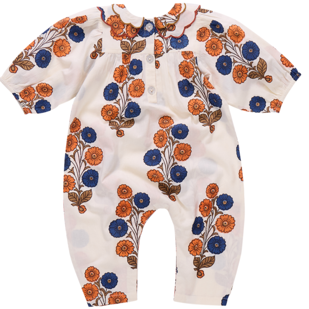The Pink Chicken Baby Girls' Dary Jumper features a Buttercup Floral print in orange and blue, short sleeves, a scalloped collar, and front buttons.