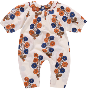 The Pink Chicken Baby Girls' Dary Jumper features a Buttercup Floral print in orange and blue, short sleeves, a scalloped collar, and front buttons.