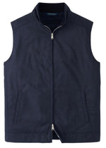 The Peter Millar Excursionist Lite Vest, a dark blue lightweight zip-up made from water-resistant wool, features a high collar and two front pockets, displayed on a plain white background.