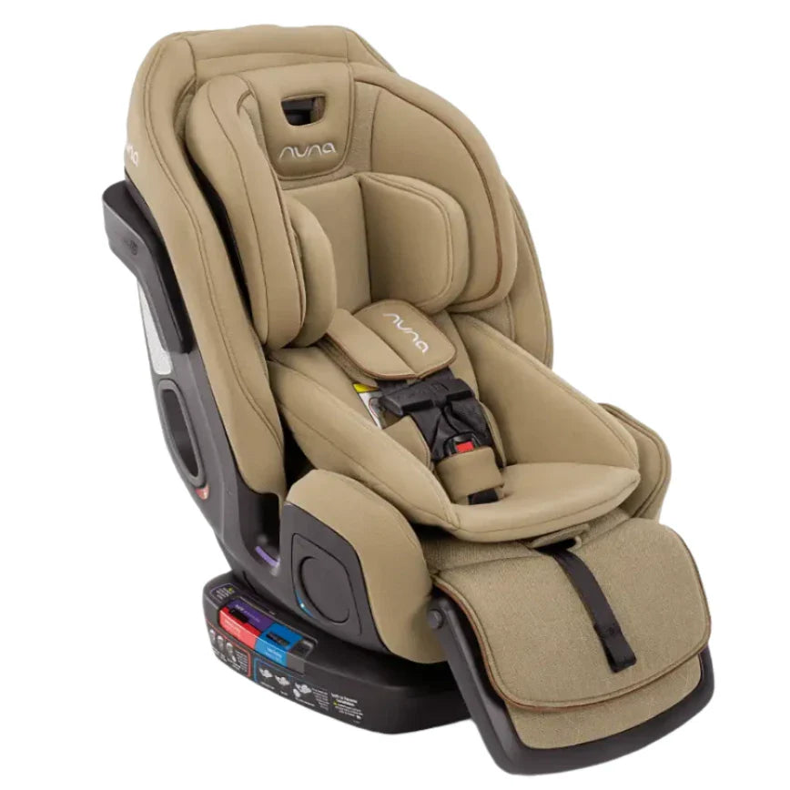 Introducing the Nuna EXEC with Slip Cover and 2nd Insert, a premium tan-colored convertible car seat from Nuna. It features padded cushions, multiple adjustment points, and a secure harness system complete with Aeroflex side impact protection, ensuring maximum safety for your infant or toddler during car travel.