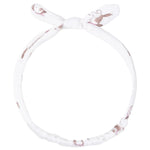 The Angel Dear Knot Headband features a white fabric with a subtle brown animal print and a charming tied bow on top, making it the perfect stylish accessory for babies.
