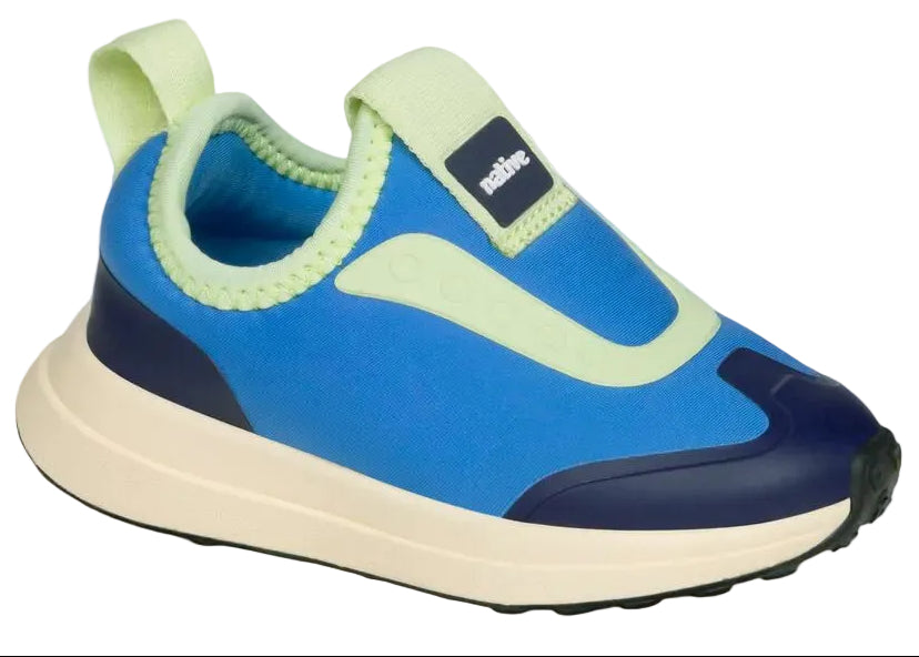 The Kids’ Robbie Dash Sneakers from Native Shoes showcase a breathable mesh upper in blue and light green, complemented by a cream sole and dark blue accents on the toe and heel, displayed against a white background.