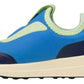 A side view of the Kids’ Robbie Dash Sneakers by Native Shoes, featuring a breathable blue and neon green mesh upper, a cream-colored sole, and black tread.