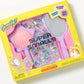 The Super Smalls Unicorn Style & Shine Gemify Beauty Kit features a sparkly brush, mirror, and decorative gems for DIY crafting in vibrant yellow packaging with purple and pink accents—perfect for kids.