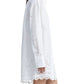 A person is wearing a white, long-sleeved Altuzarra Morton Dress with broderie anglaise and scalloped edges. The image shows a side view of the outfit.