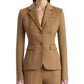 A person wearing the Altuzarra Fenice Jacket, expertly tailored in a camel-colored virgin wool blend with matching pants, stands against a plain background.
