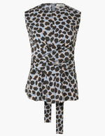 The Tizzy Top by Altuzarra is a sleeveless piece showcasing a blue, black, and beige leopard print. It features a round neckline, a cinched waist with belted detail, and long fabric ties at the front.