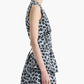 A woman wearing the Altuzarra Tizzy Top, a sleeveless blue and black leopard print style with a round neckline, is shown from the side against a plain white background.
