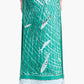 A person wearing the Altuzarra Linnie Silk Skirt, shown from the back, styled with black high-heeled sandals. The skirt features a green fish and net pattern, a fitted waist, and a straight silhouette for an elegant look.
